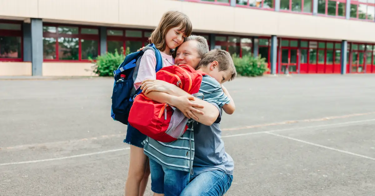Elementary to Secondary school transition - The Emotional Rollercoaster_ What to Expect - Father hugging his children